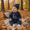 CuddleBaby – Hola, soy nueva aquí: Conjunto de mono y gorrito para bebé